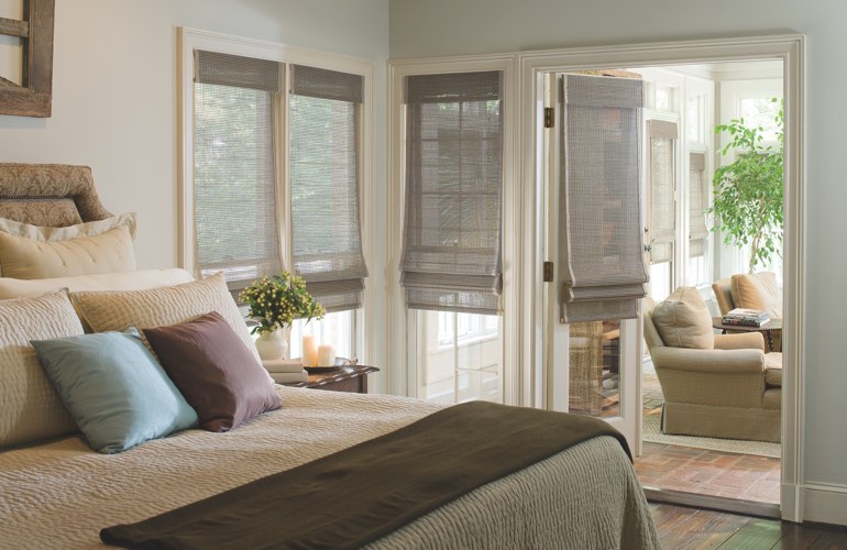 Bedroom with woven shades on windows